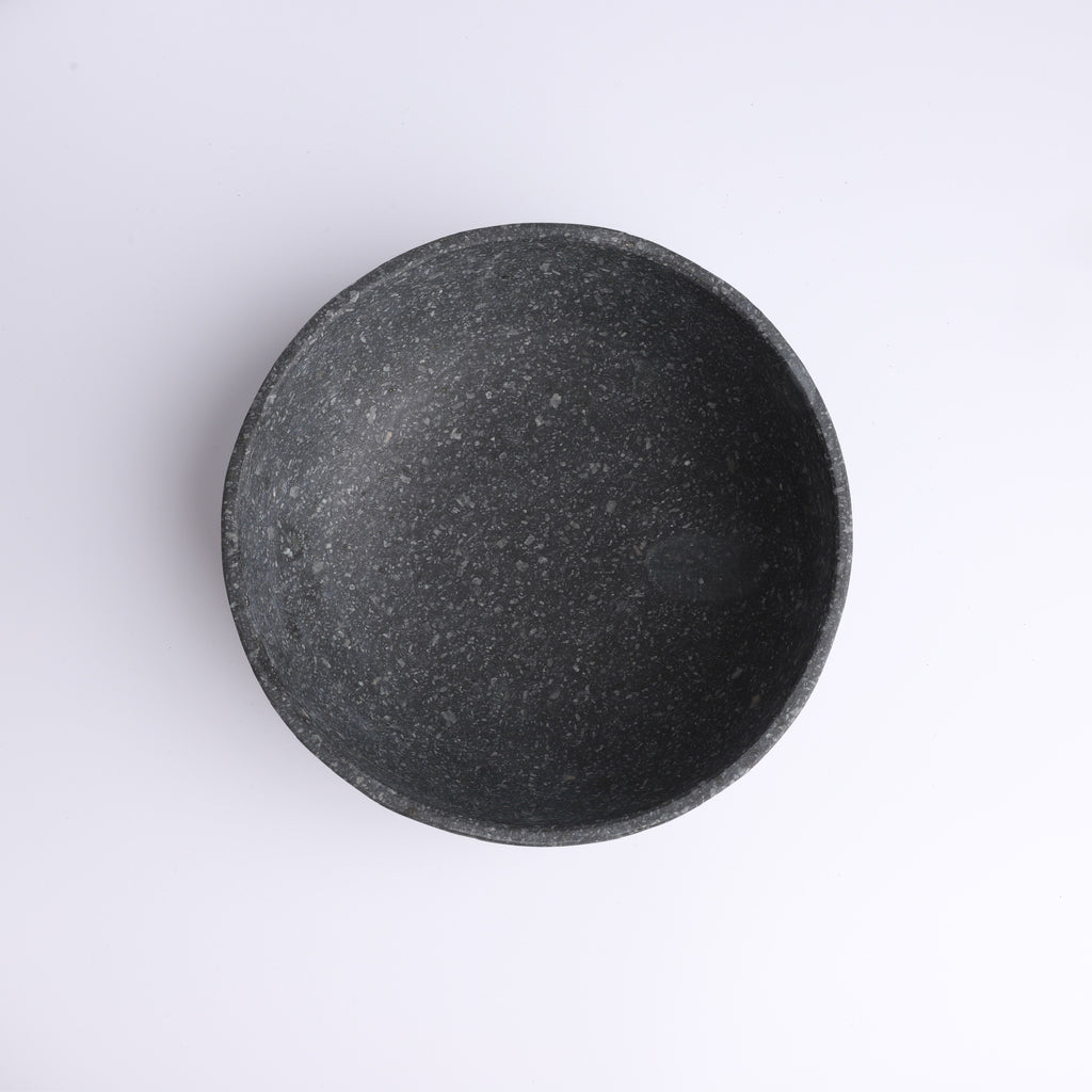 Top view of handcrafted charcoal stone bowl with natural speckled texture