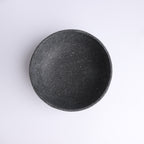 Top view of handcrafted charcoal stone bowl with natural speckled texture