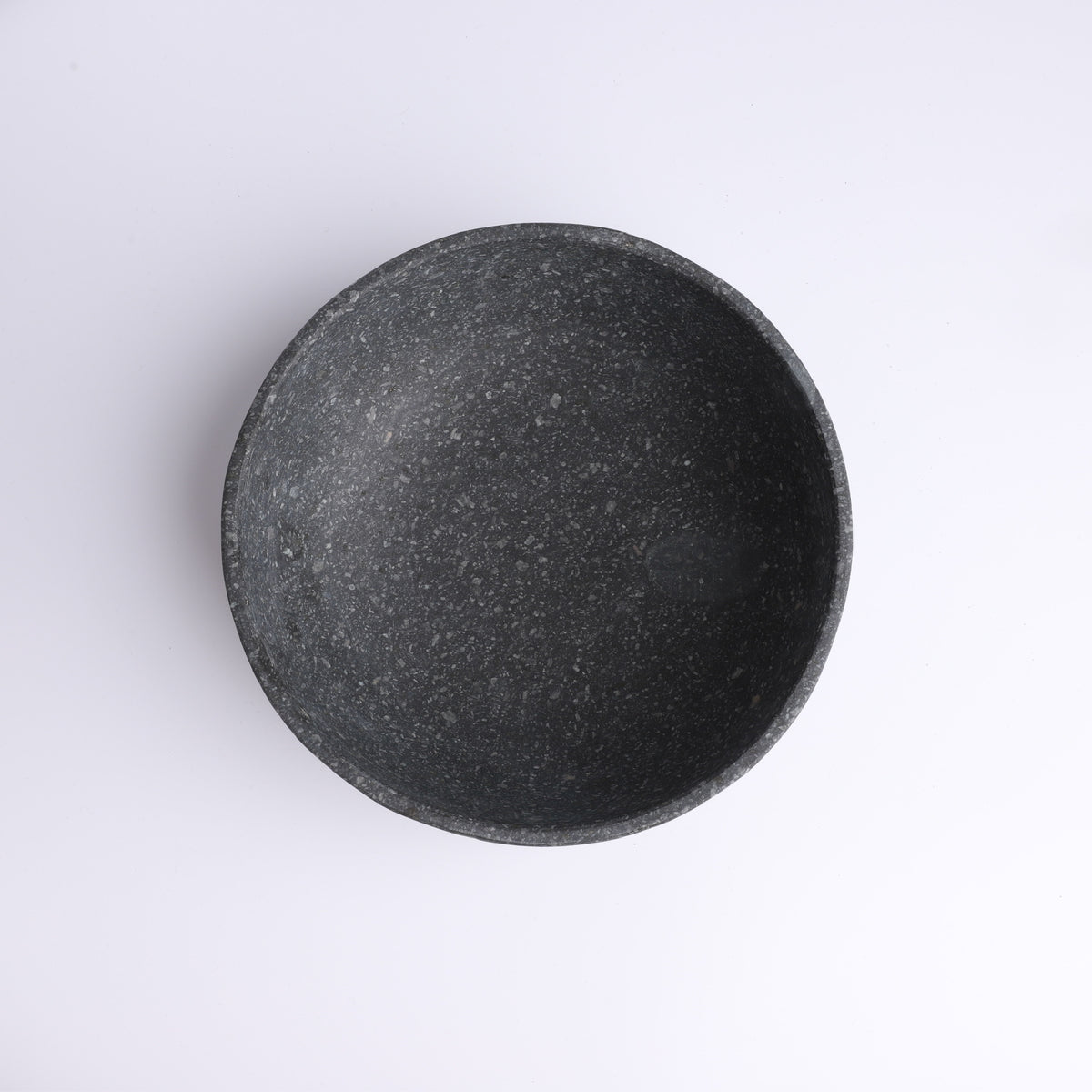 Top view of handcrafted charcoal stone bowl with natural speckled texture